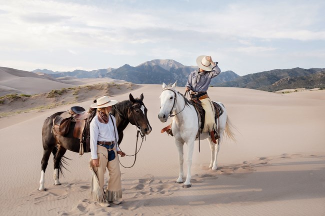 Two women on horseback at Great Sand Dunes