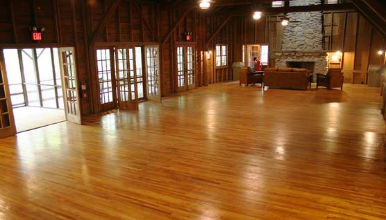 Interior view of the Appalachian Clubhouse with wooden floors, french doors and fireplace
