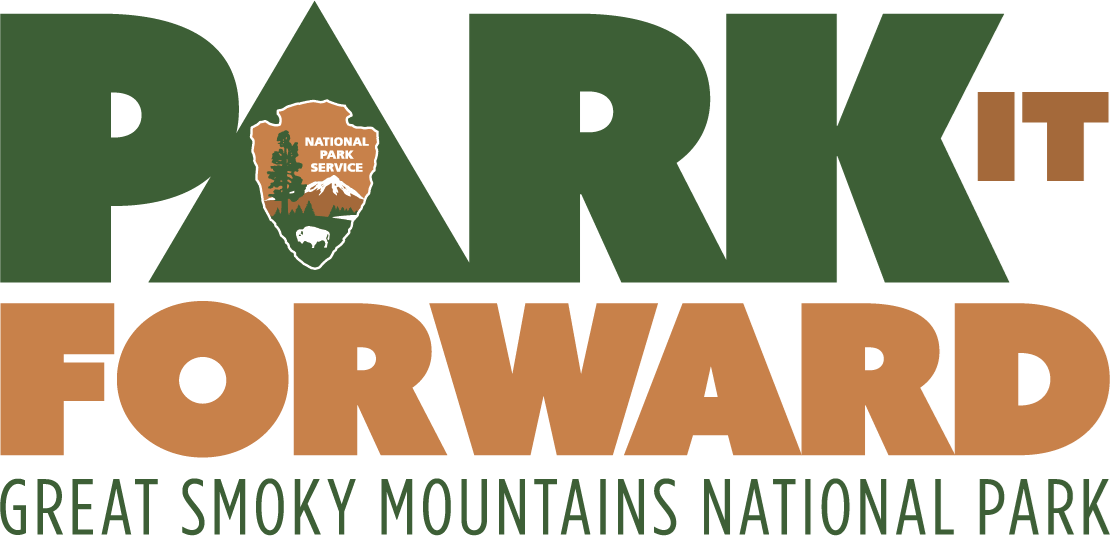 White background with bold, capital green & brown text in two lines, "Park it Forward". "PARK" is green, and 'A' has the National Park Service logo in it. "IT FORWARD" is brown. Thinner green text below says, “Great Smoky Mountains National Park”.