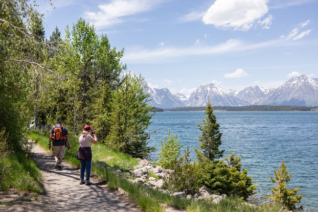 Visitors on pathway next to Jackson Lake