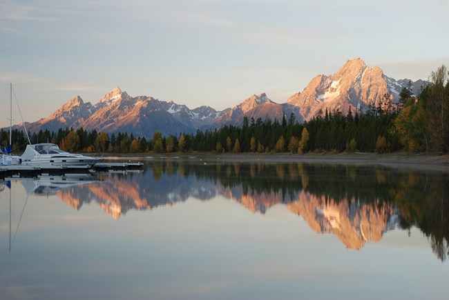 Bay with boat and mountains in the background.