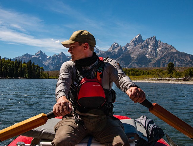 Ranger wearing a personal floatation device on Snake River