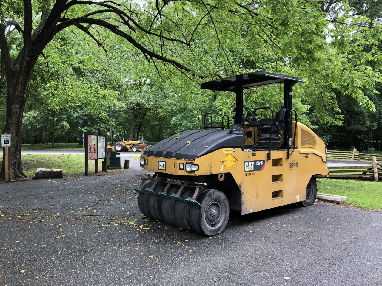A CAT paving machine sits in a parking lot