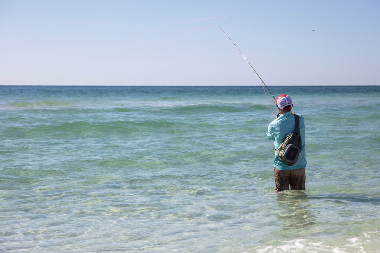 Man in water fishing