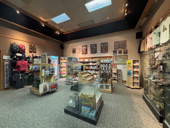 Park store with various items for sale such as stickers, shirts, books, puzzles and more.