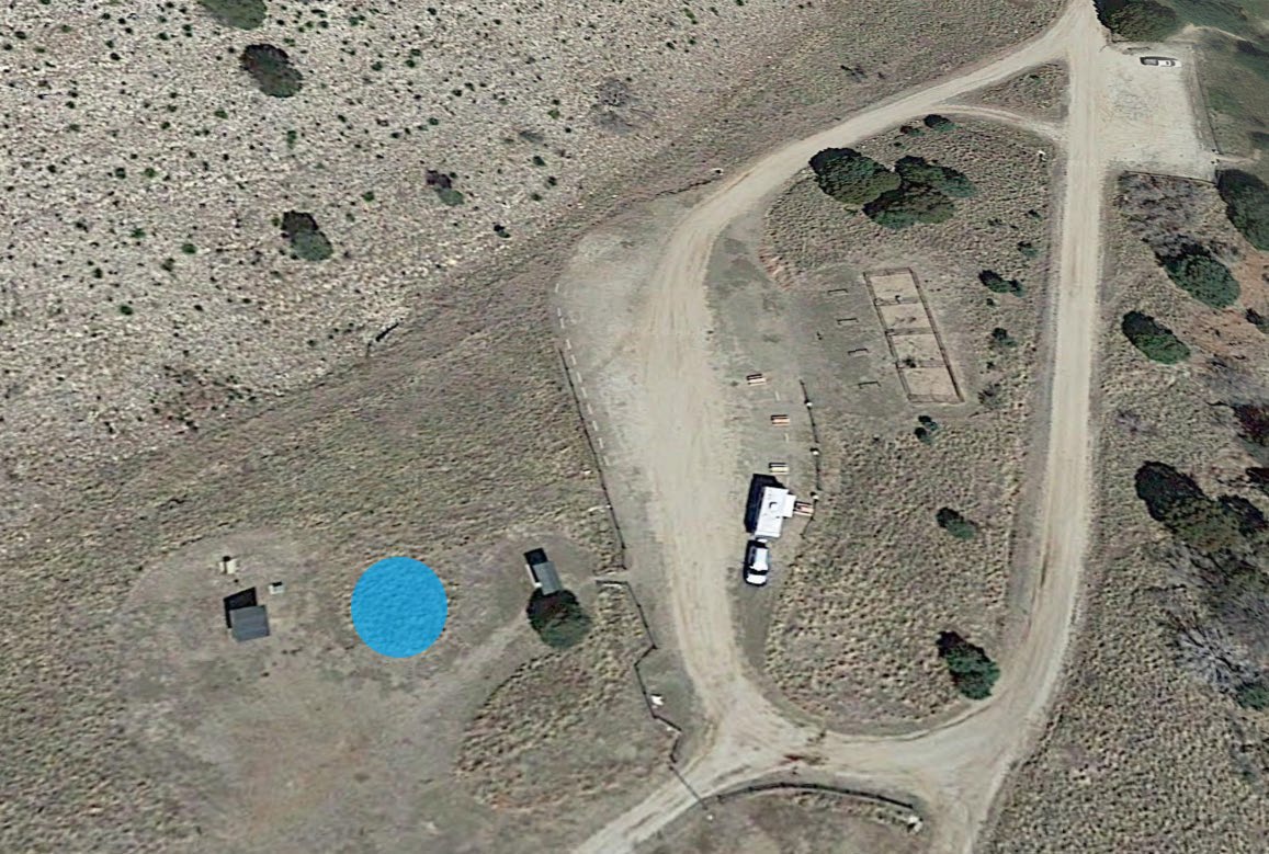 Satellite photograph showing the area between the trailhead sign and small well house.