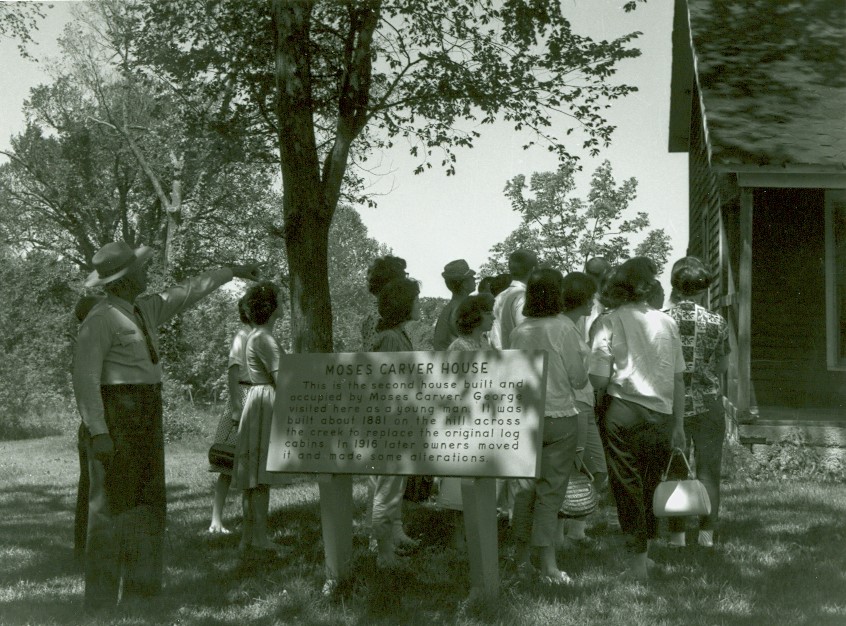 Black and white image of a park ranger conducted a guided tour.