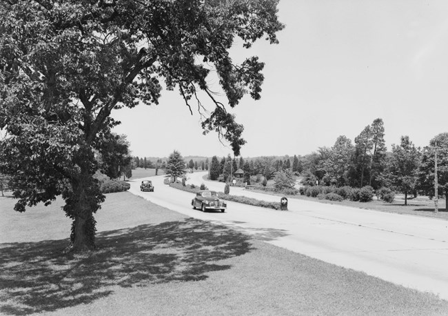 Historic image of car driving on road.
