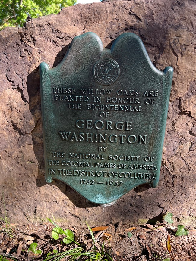 A plaque attached to a stone.
