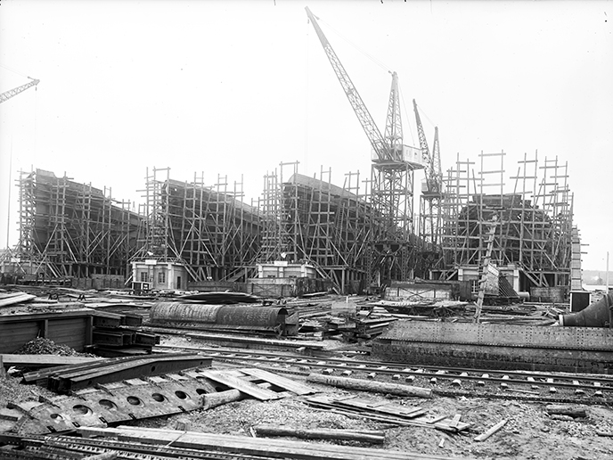Four partly completed ships line the shore in Alexandria