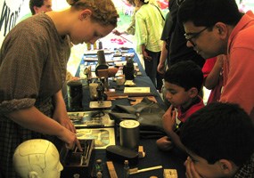 Polly Root explains early medicines to interested visitors.