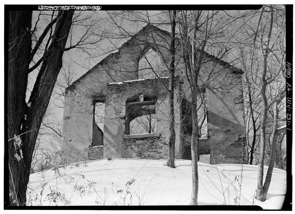 black and white photo of church ruins, which are mostly stone walls