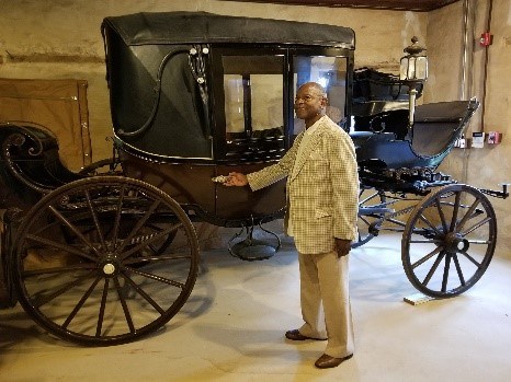 John Gross stands with one of the carriages his ancestor Nathan Harris likely drove at Hampton.