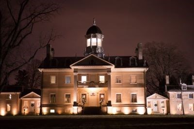 Modern day view of the Hampton mansion lit up at night.