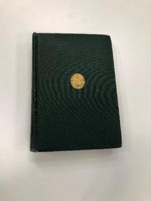 black cover of book with gold circle seal in middle