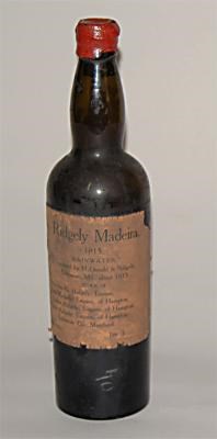 Brown bottle with red wax top and brownish label