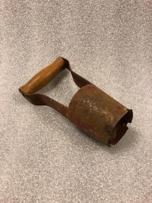 photo of brown oblong object with wooden handle