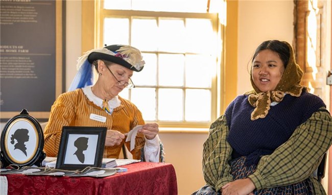 Person posing for a handmade 19th-century silhouette
