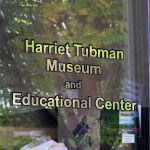 Harriet Tubman Museum and Education Center in gold letters on glass door