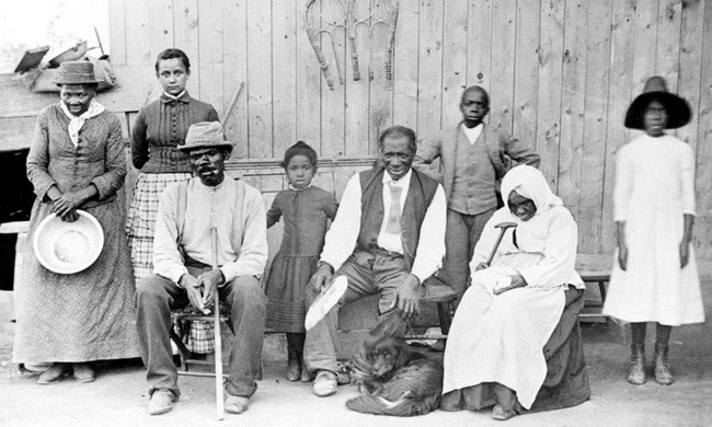 African American family of all ages in front of a house