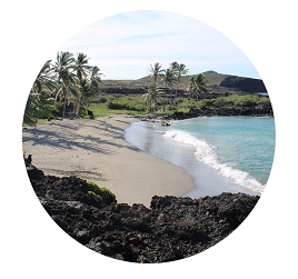 White sand beach surrounded by lava rock.