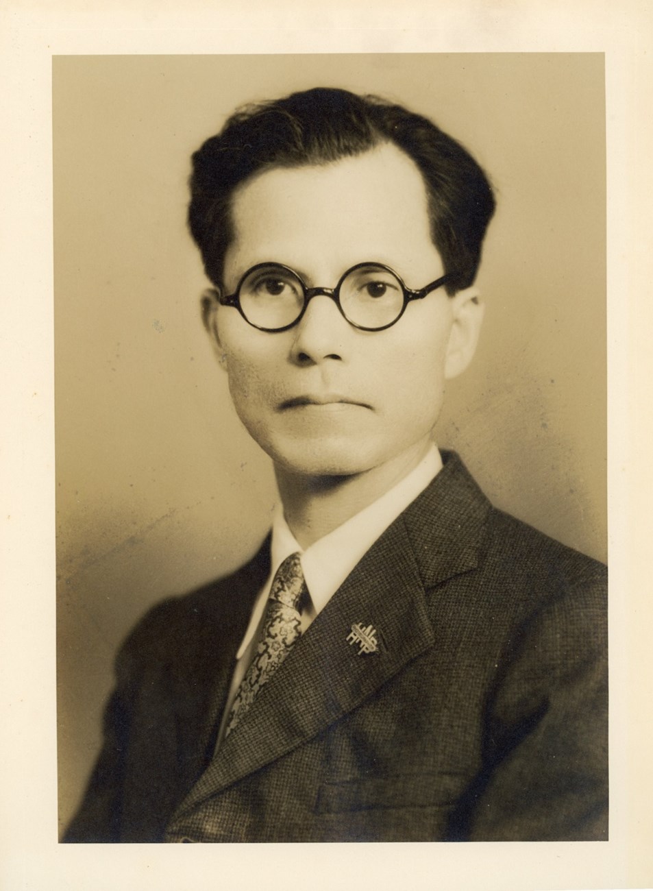 A black and white photograph of Kenichi Maehara