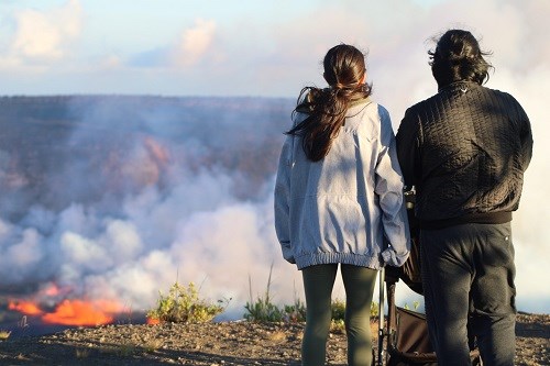 Image of a family viewing a crater filled with lava.