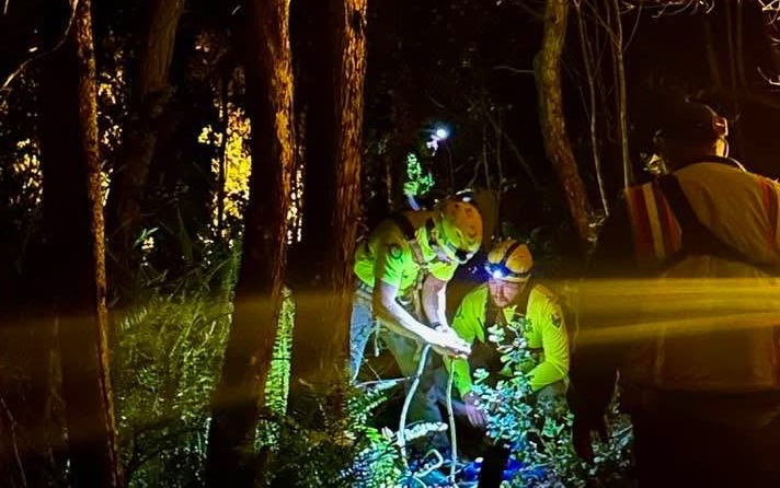 First responders prepare to rappel down a cliff to rescue someone