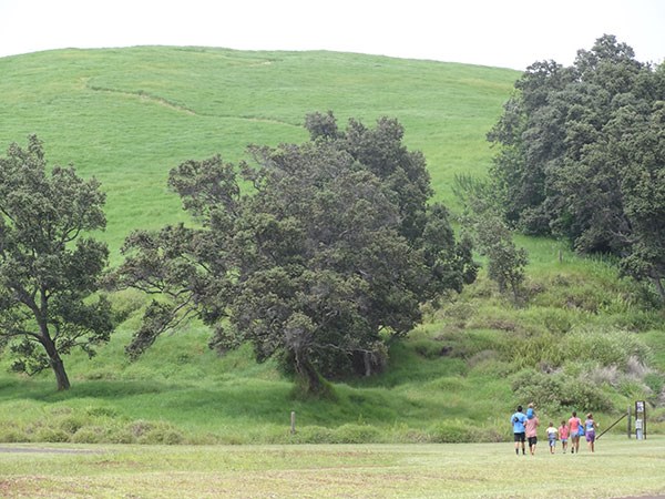 A family at the base of Pu‘u o Lokuana in the Kahuku Unit