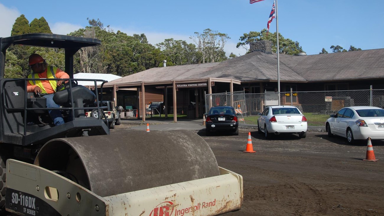 Large construction equipment operating in front of visitor center.