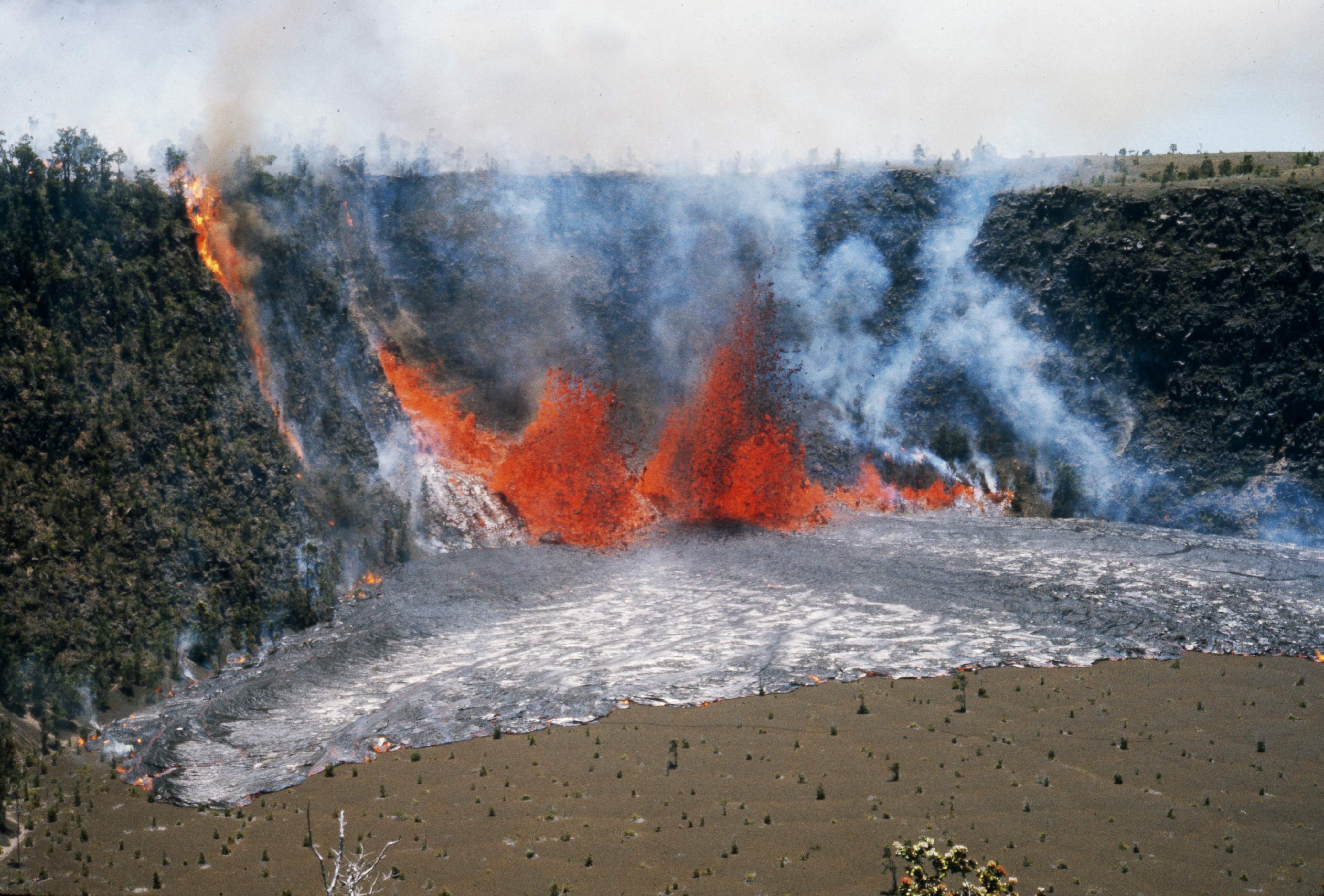 Lava fountaining from a fissure in the wall of a crater