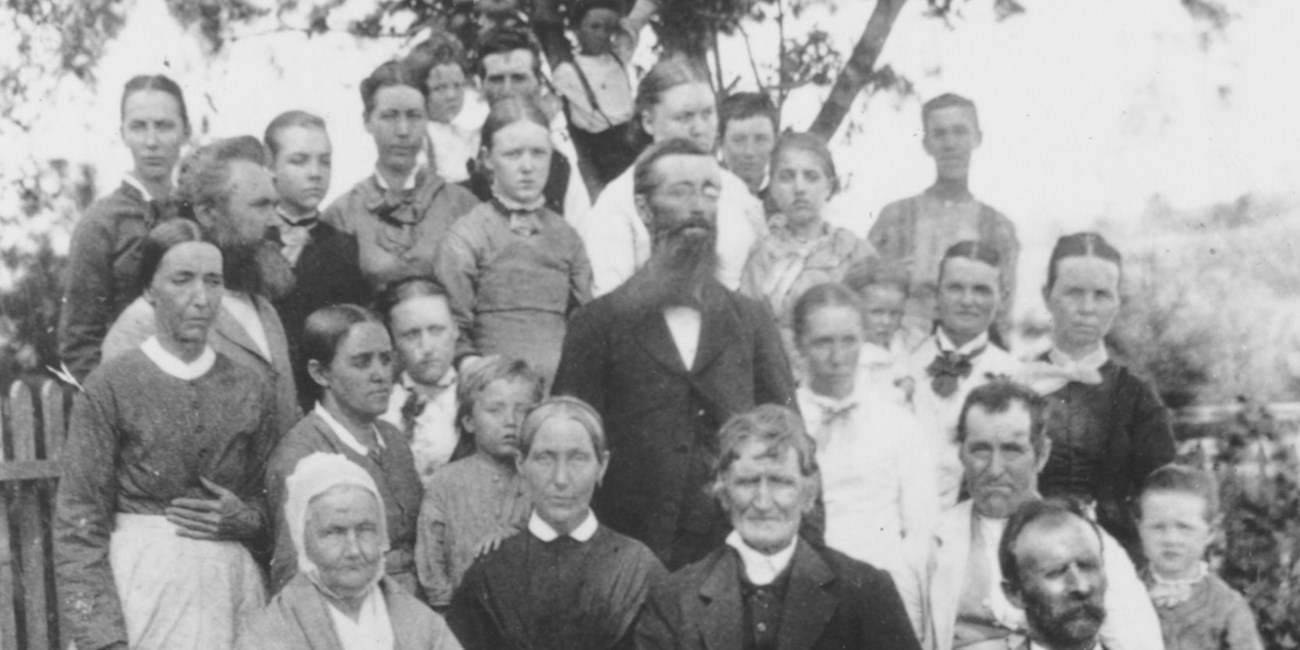 An extended multigenerational family poses during a picnic in 1878.