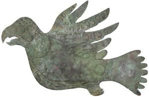 A green oxidized piece of copper cut out to a bird shape