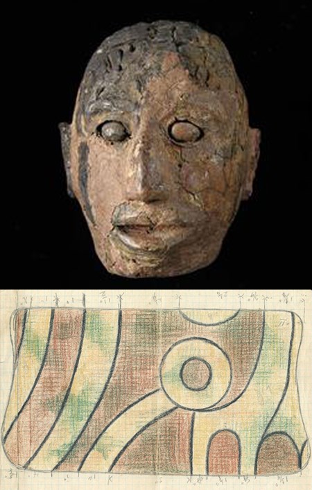 A stone effigy head and a drawing of a pattern on cloth