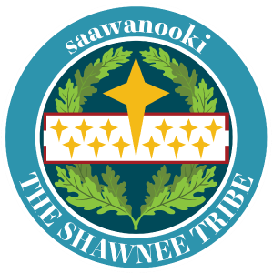 seal depicts a field of blue an oak leaf laurel overlayed with a white band containing 12 yellow four point stars and matching yellow star on the top half of the emblem. text saawanooki and The Shawnee Tribe on outer band.