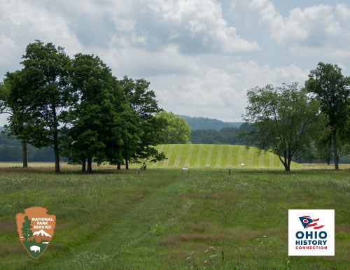 Grass-covered mound of dirt in background with trees surrounding the mound, NPS arrowhead and OHC logo in foreground.