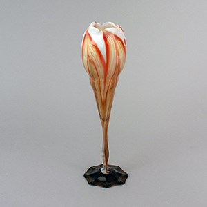 A glass vase in form of a tulip.