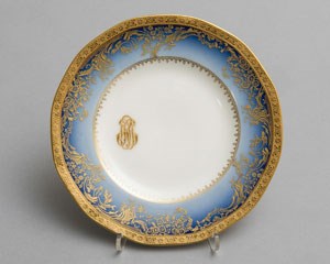 A round porcelain plate with wide cobalt and gilt rim, monogramed in gold with FDR's initials in script.
