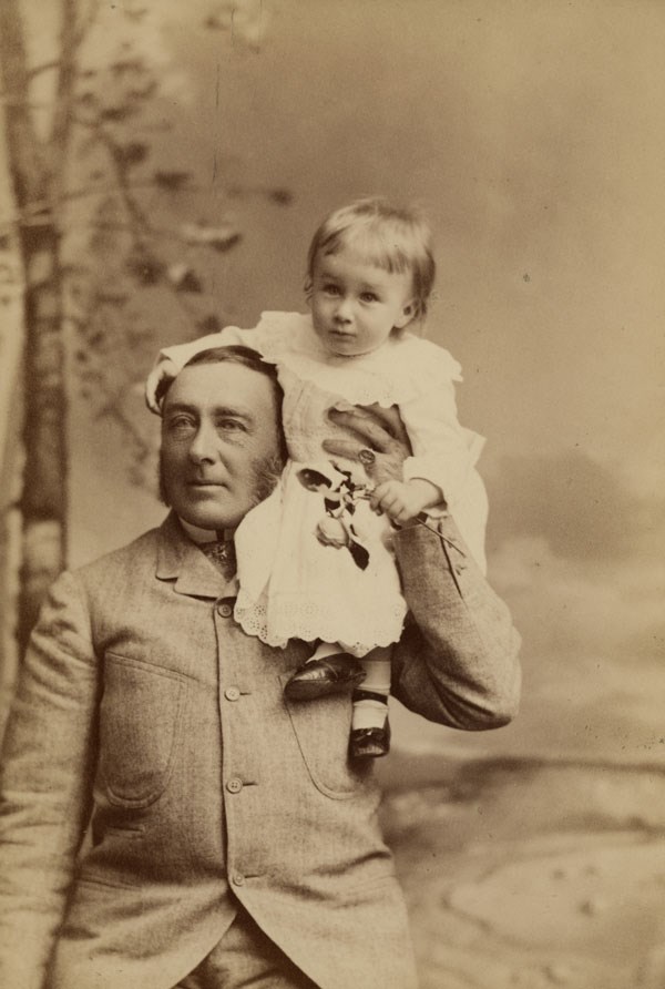 Photograph of Franklin as a baby sitting on James' shoulder.