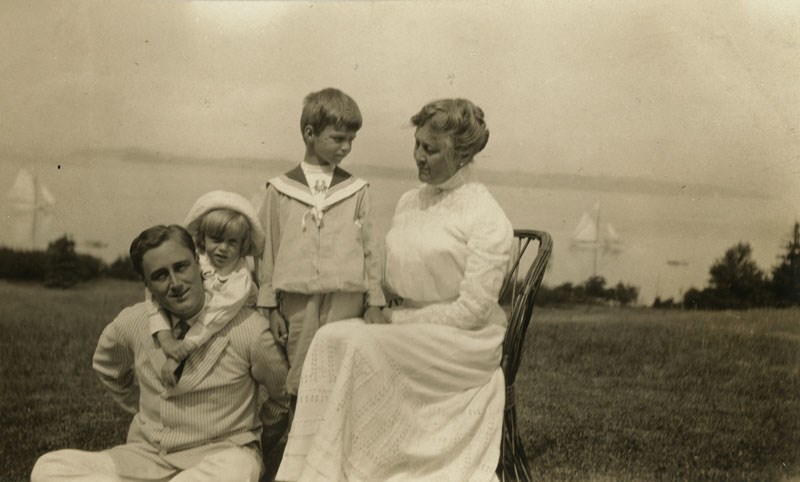 Sara with Franklin and two grandchildren on the shore of Campobello Island.