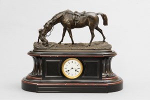 A mantle clock with bronze sculpture of horse and dog.