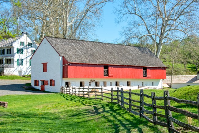 Red and white barn housed animals at Hopewell Furnce.