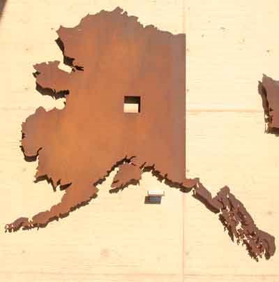 Cutout in the shape of Alaska with a cutout showing the amount of homesteaded land