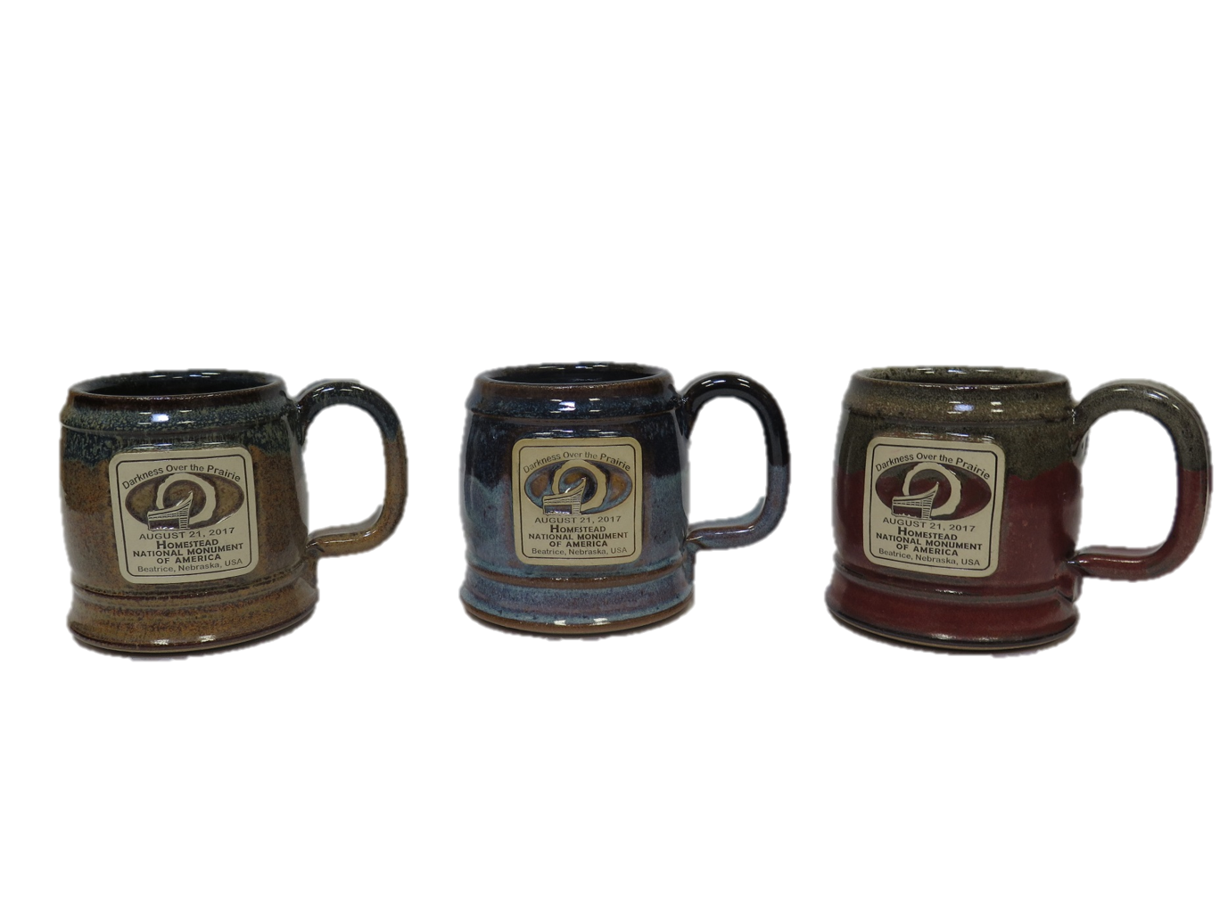 Shows three styles of mugs with Darkness Over the Prairie Logo