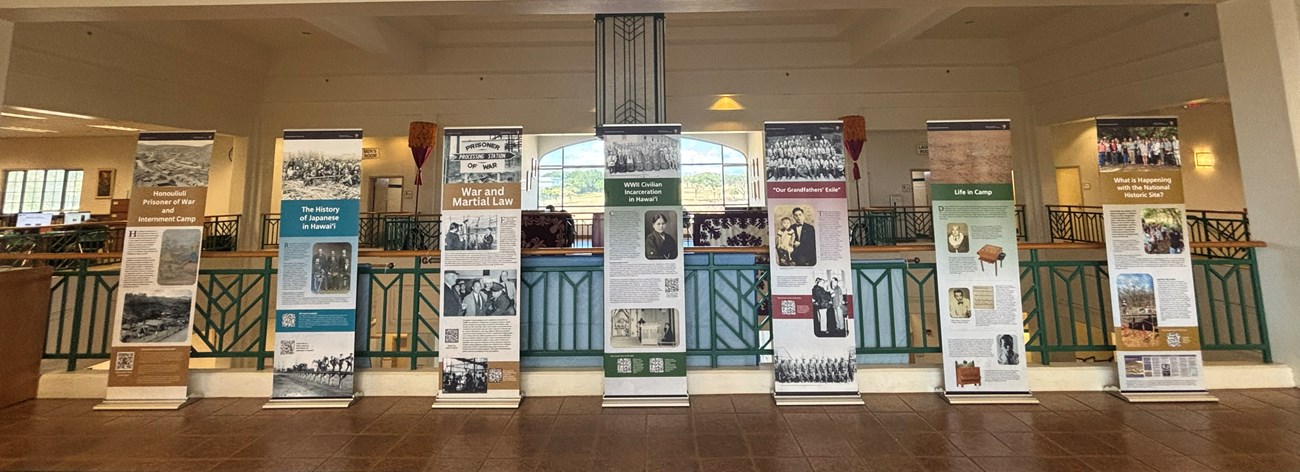 Seven vertical banners with text standing in a row