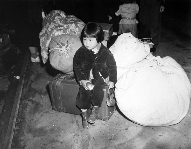 Yuki Okinaga Hayakawa sitting on luggage