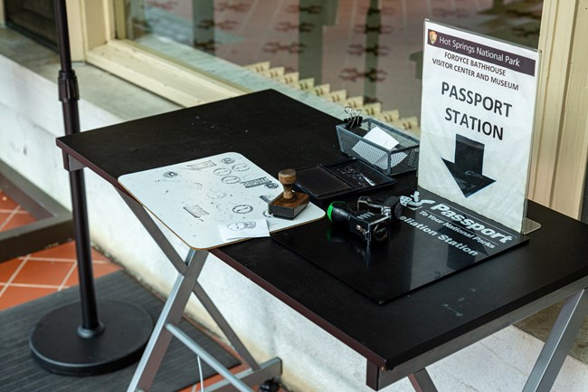 A table with stamps and paper for your passport
