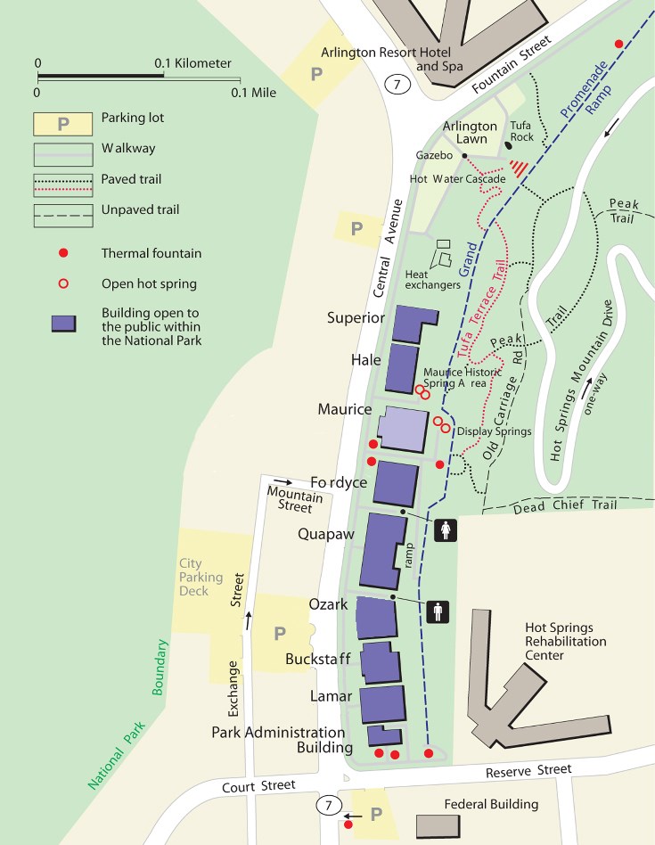 Map depicts downtown area in pale yellow and the parklands in green. The bathhouse buildings that are occupied are shown in purple, while the Maurice is shown in lilac. Fountains and springs are shown as red dots. Walking trails are shown as dashed lines.