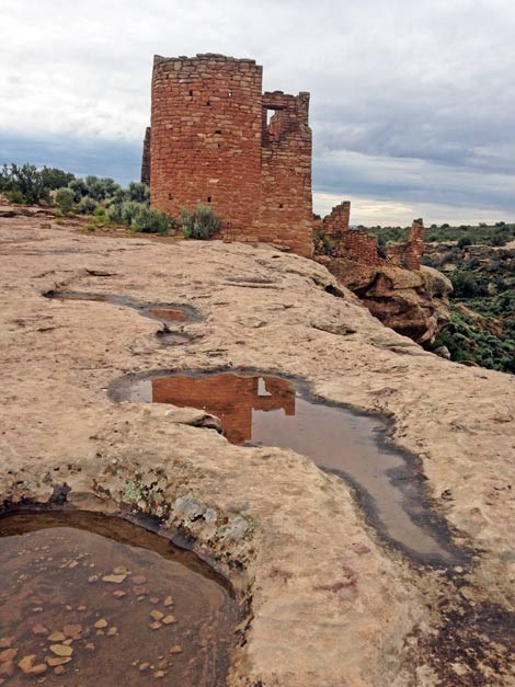 potholes in slickrock filled with water in front of Hovenweep Castle
