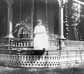 Bess Wallace sits on porch of her Independence home, circa 1905.